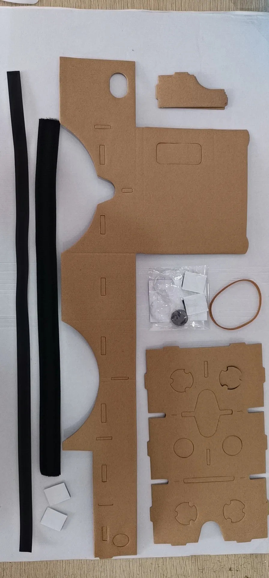 Pink and white VR cardboard glasses viewer for smartphones with adjustable head strap.