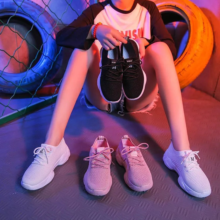 Women's white sport shoes with thick rubber soles and woven upper fabric with front strap closure