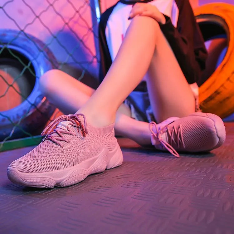 Women's white sport shoes with thick rubber soles and woven upper fabric with front strap closure