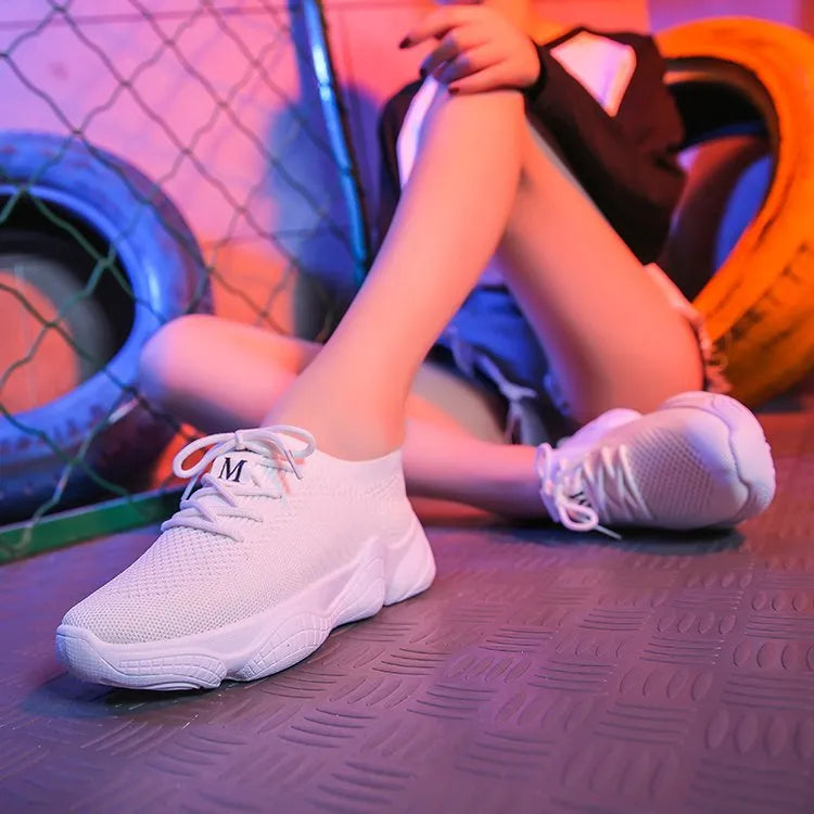 Women's white sport shoes with thick rubber soles and woven upper fabric with front strap closure