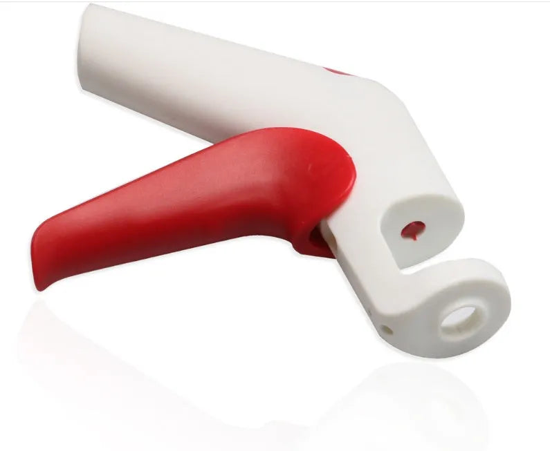 A manual cherry kernel remover kitchen tool with a handle for pitting cherries