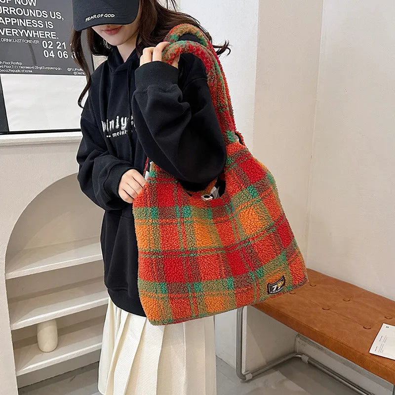 Women's soft plush plaid crossbody tote bag showing large capacity and zipper pocket in horizontal square design.