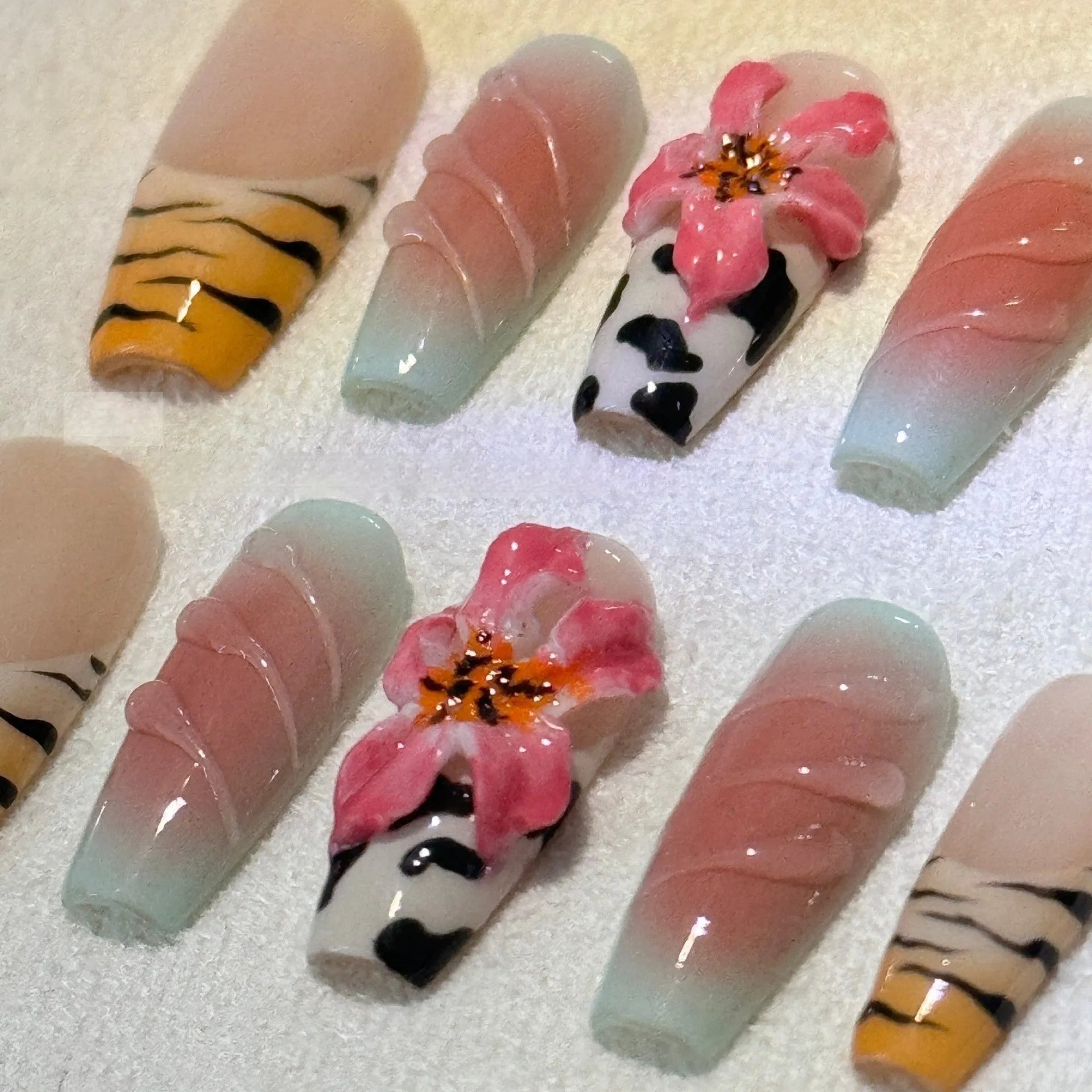 Hand carved zebra pattern nail art with embossed flower and leopard print designs in four size options