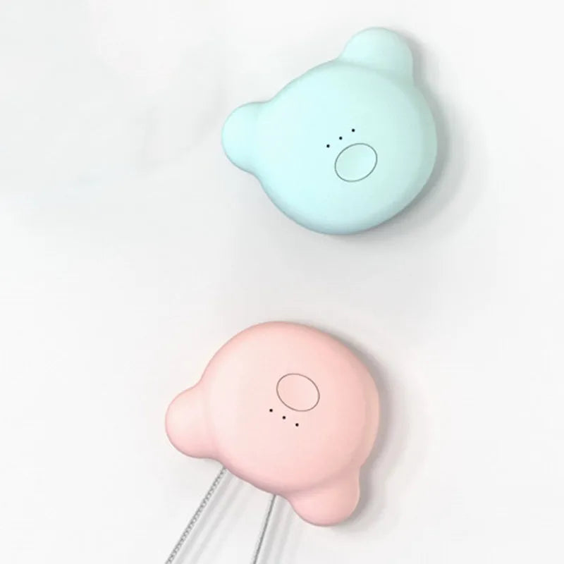 Pink and blue wearable USB air purifier necklace shown on a person, with dimensions 1.5 by 5.7 by 4.5 cm.