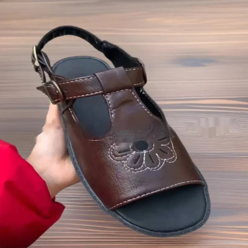 Men's black embroidered floral beach sandals with a flat heel, showing PU upper material.