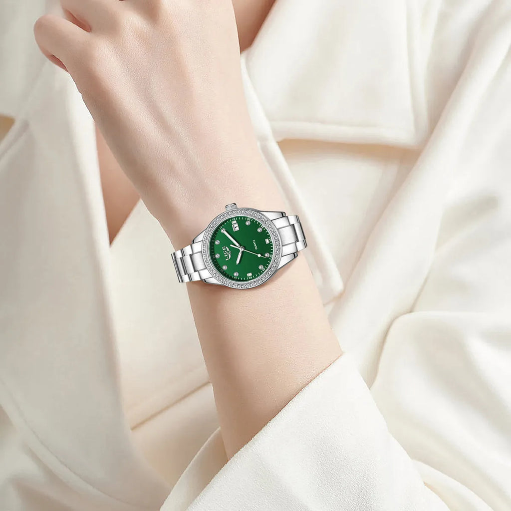 Women's silver fashion quartz watch with diamond bezel, luminous hands on a coloured dial, showing side profile with spiral crown.