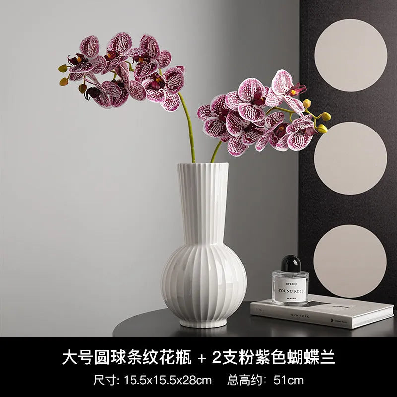 White ceramic ball-shaped vase with striped American country design on a table.