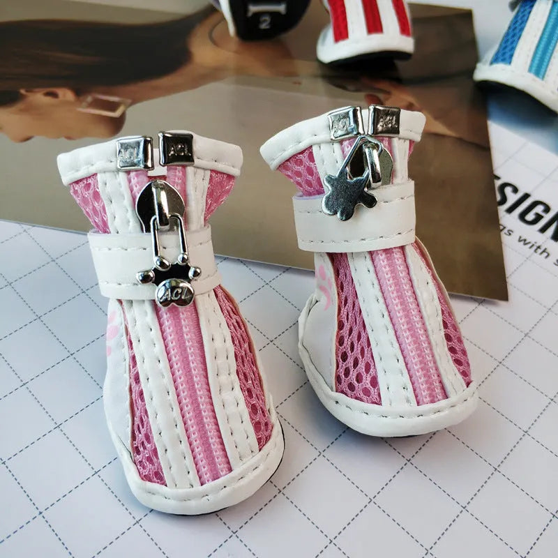 Set of four blue cloth dog shoes for small dogs with non-slip soles and a zip fastening.