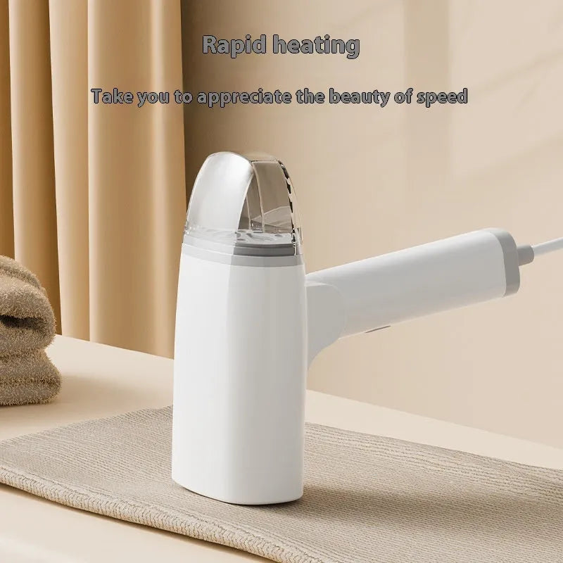 Blue and white handheld garment steamer with water tank and power cord on a white background.