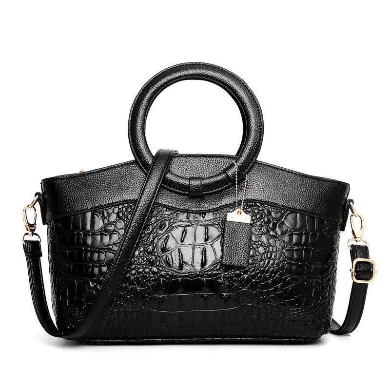 Brown fabric women's handbag showing front zipper compartment and internal organiser pockets.