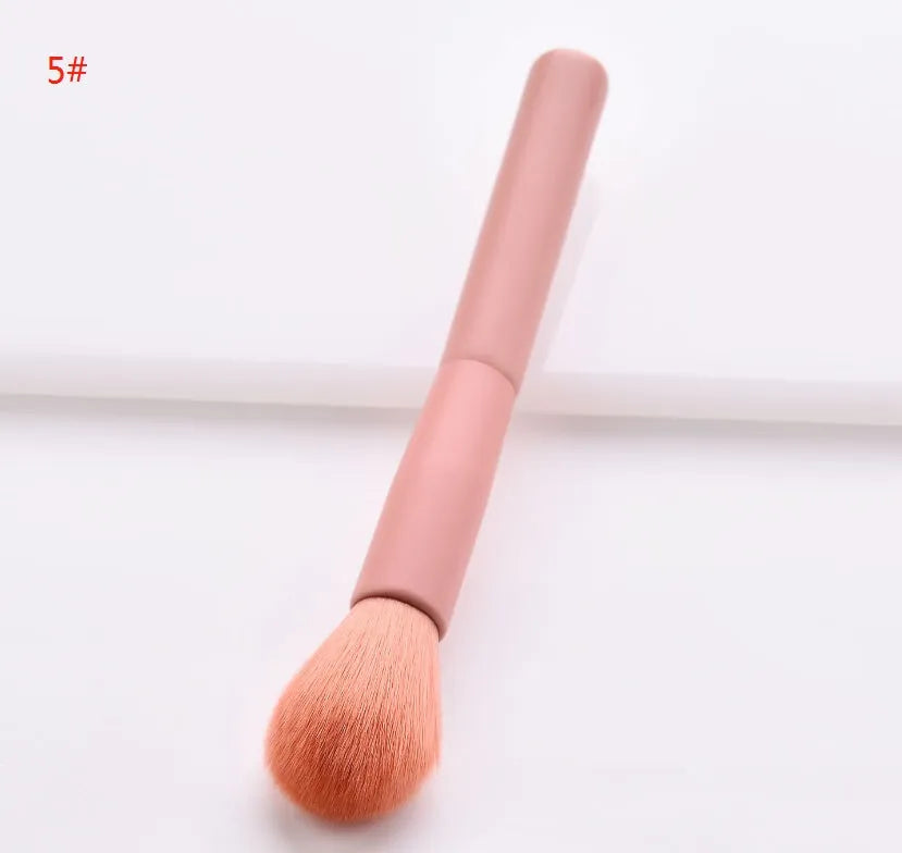 10 professional makeup brushes with wooden handles, including powder, foundation, and double-ended detail brushes.