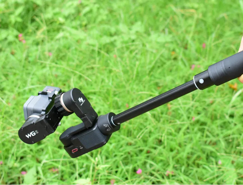 Black retractable selfie stick with stabilizer grip extended to full length with phone attached