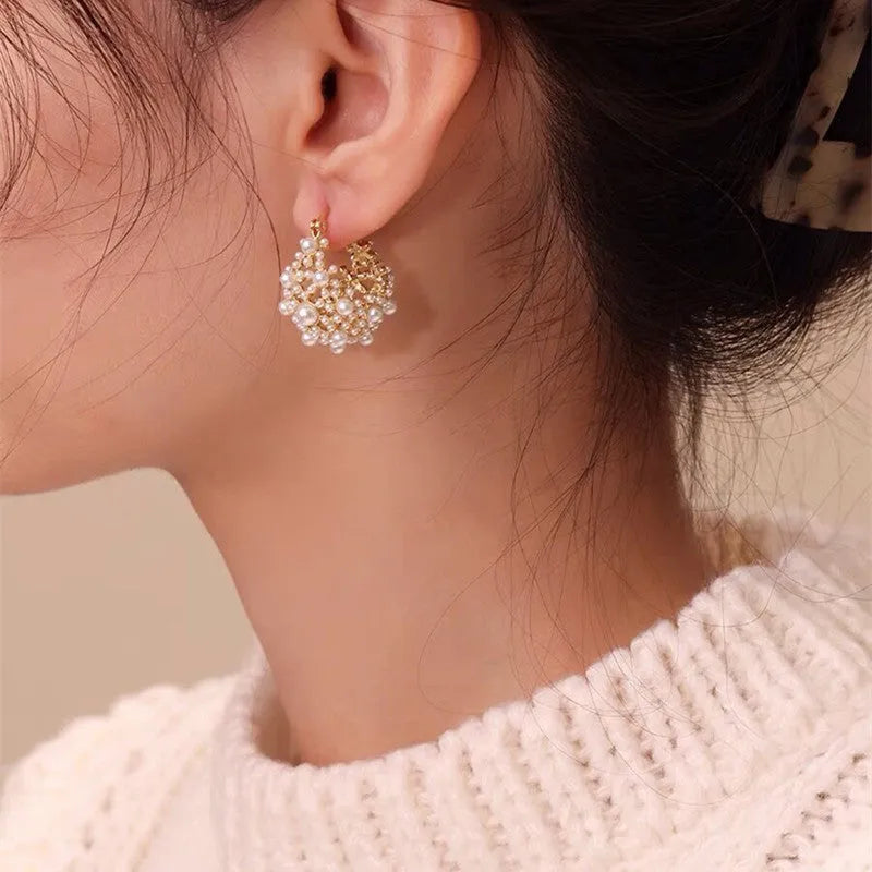 Gold-coloured copper flower basket earrings with pearl inlay and small rice-shaped bead detailing