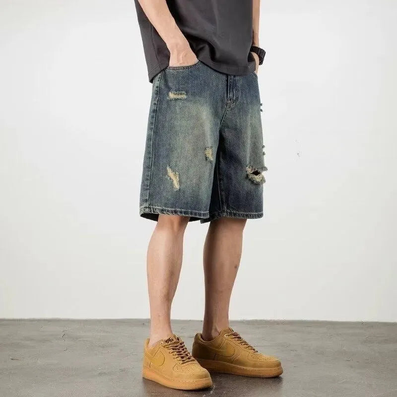 Retro blue denim men's shorts with distressed holes and straight leg cut on mannequin