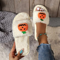 Halloween pumpkin plush slippers with synthetic fur uppers and PVC soles in white and yellow