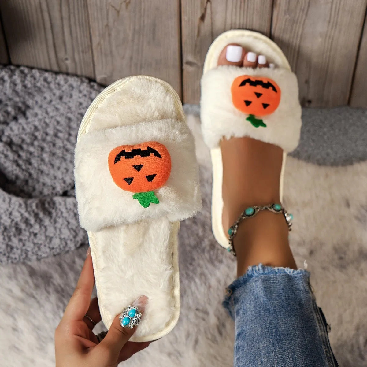Halloween pumpkin plush slippers with synthetic fur uppers and PVC soles in white and yellow