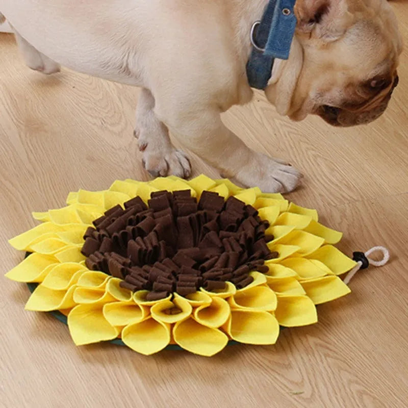 Yellow sunflower-shaped dog snuffle mat with fleece texture and a buckle strap for non-slip use.