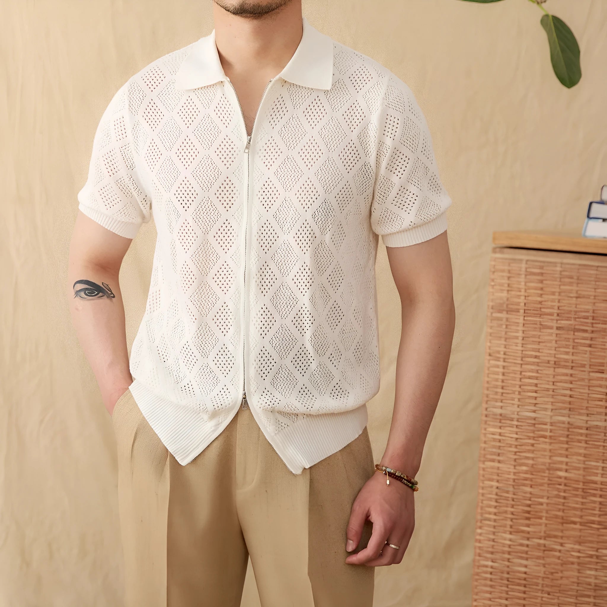 Man's light brown cotton cardigan with a front zipper, lapel collar, and short sleeves laid flat.