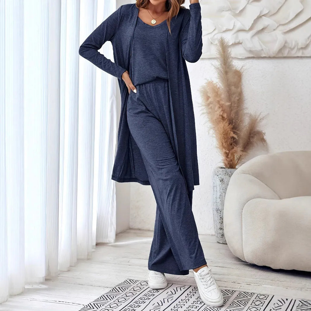 Blue women's three-piece casual suit set comprising sling top, long cardigan, and trousers on a hanger.