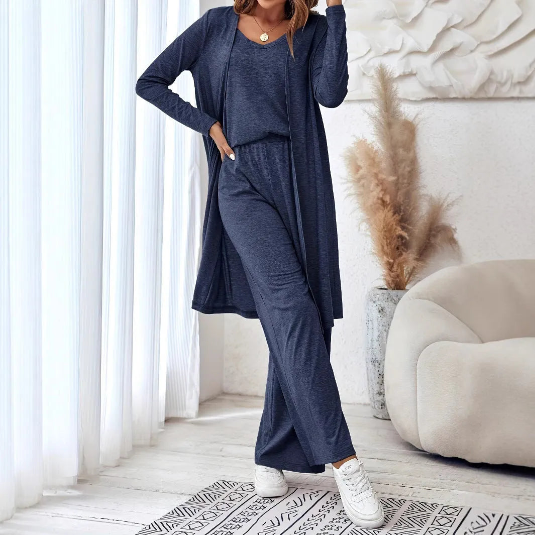 Blue women's three-piece casual suit set comprising sling top, long cardigan, and trousers on a hanger.
