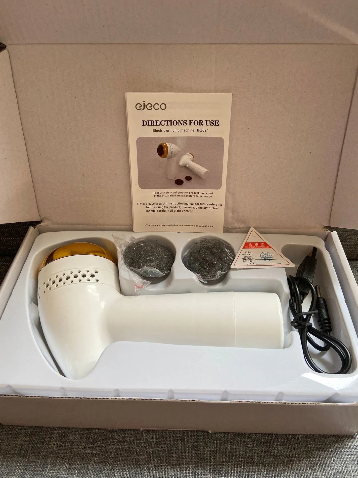 Electric vacuum foot grinder with quartz head in gold colour, showing battery and callus removal function.
