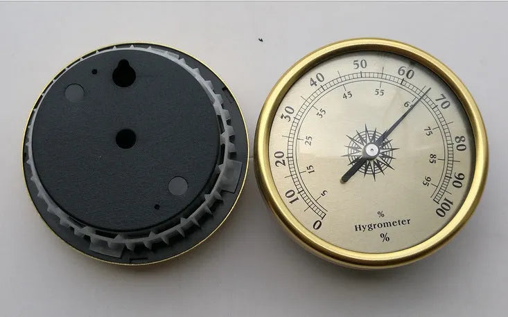 Circular aluminium analogue thermometer and hygrometer showing humidity and temperature dials