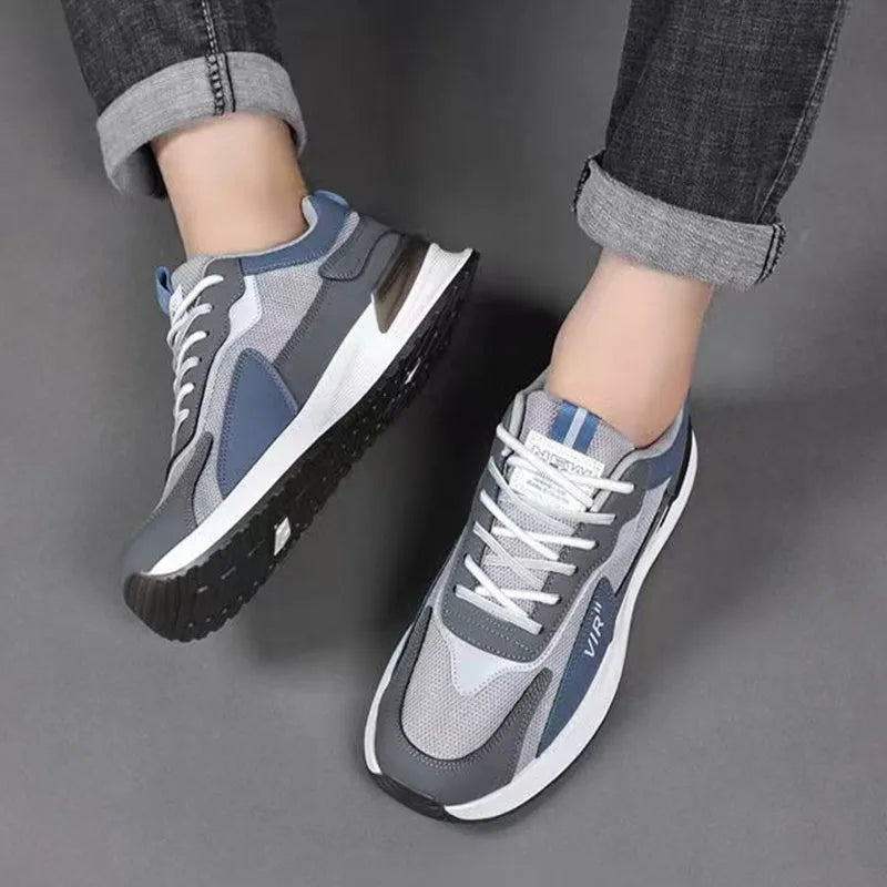 Men's colour block lace-up sneakers in grey with mesh upper and white sole.