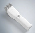 Black cordless men's electric hair clipper with adjustable slider comb and ceramic cutter head.