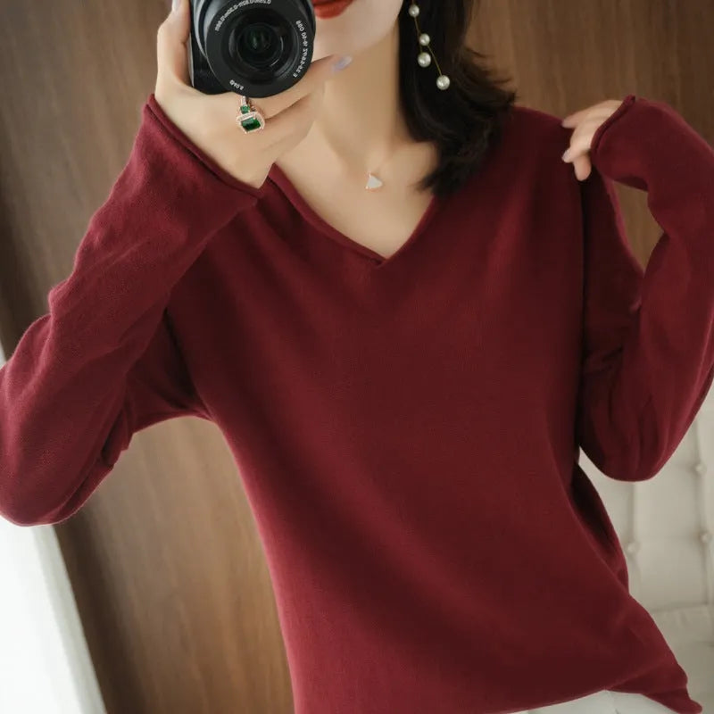 Women's V-neck long sleeve knitwear top in wine red colour, laid flat.