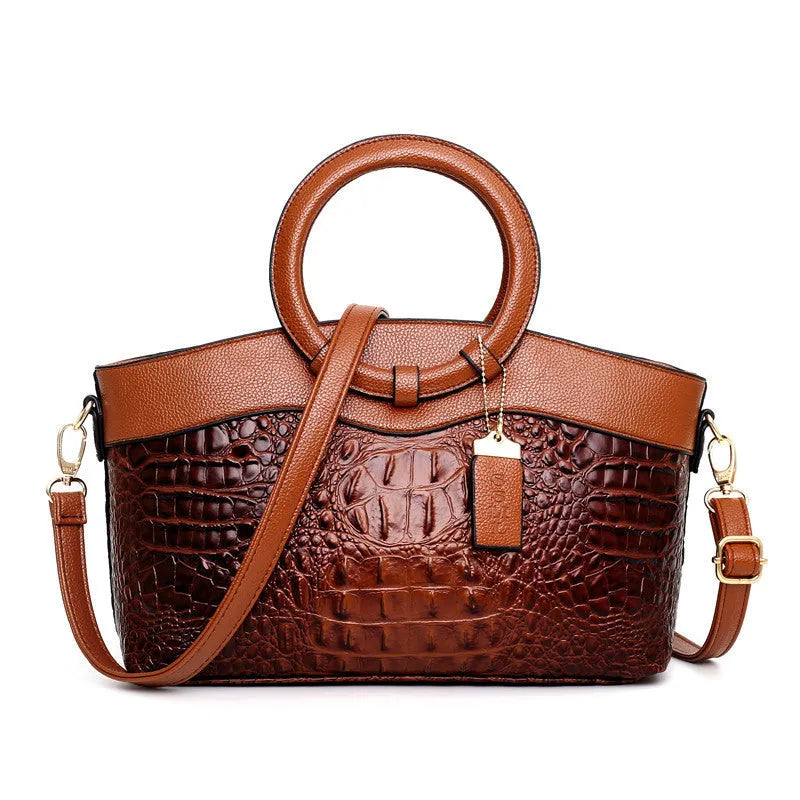 Brown fabric women's handbag showing front zipper compartment and internal organiser pockets.