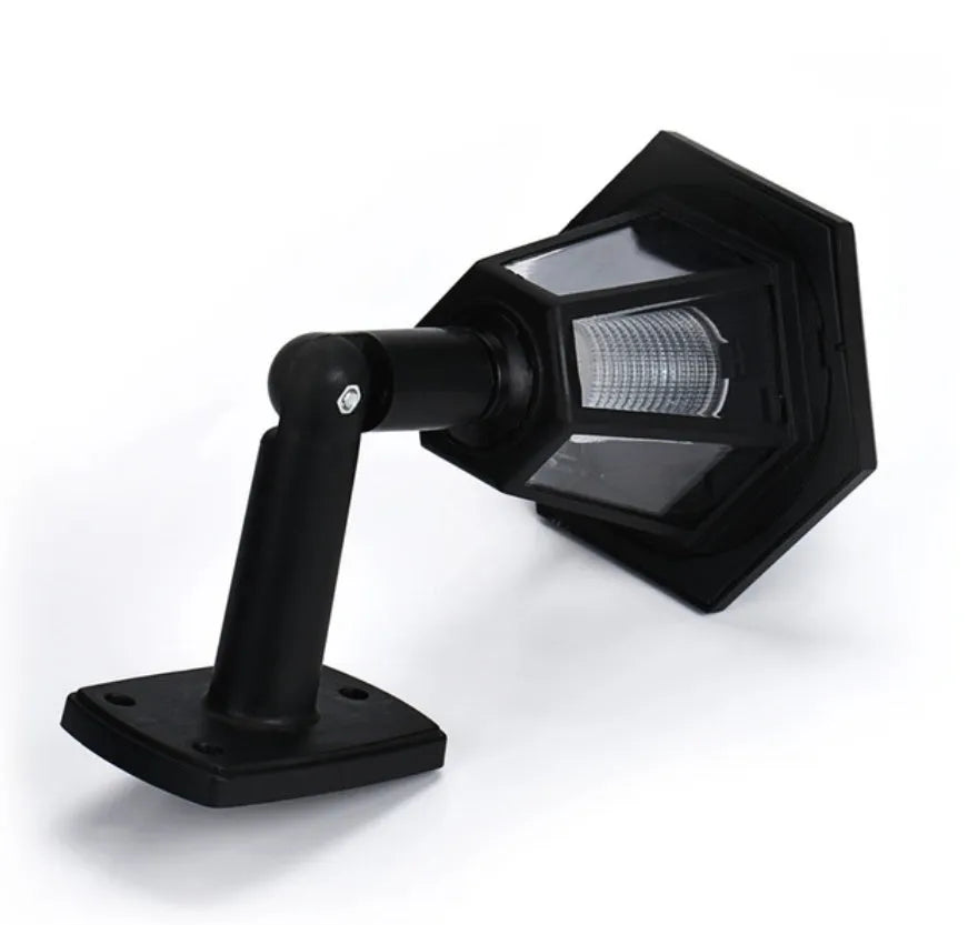 Black hexagonal solar-powered LED wall light with light sensor for outdoor garden use