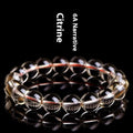 Natural citrine scattered beads ball bracelet showing 7A and 6A colour grade options on a wrist.