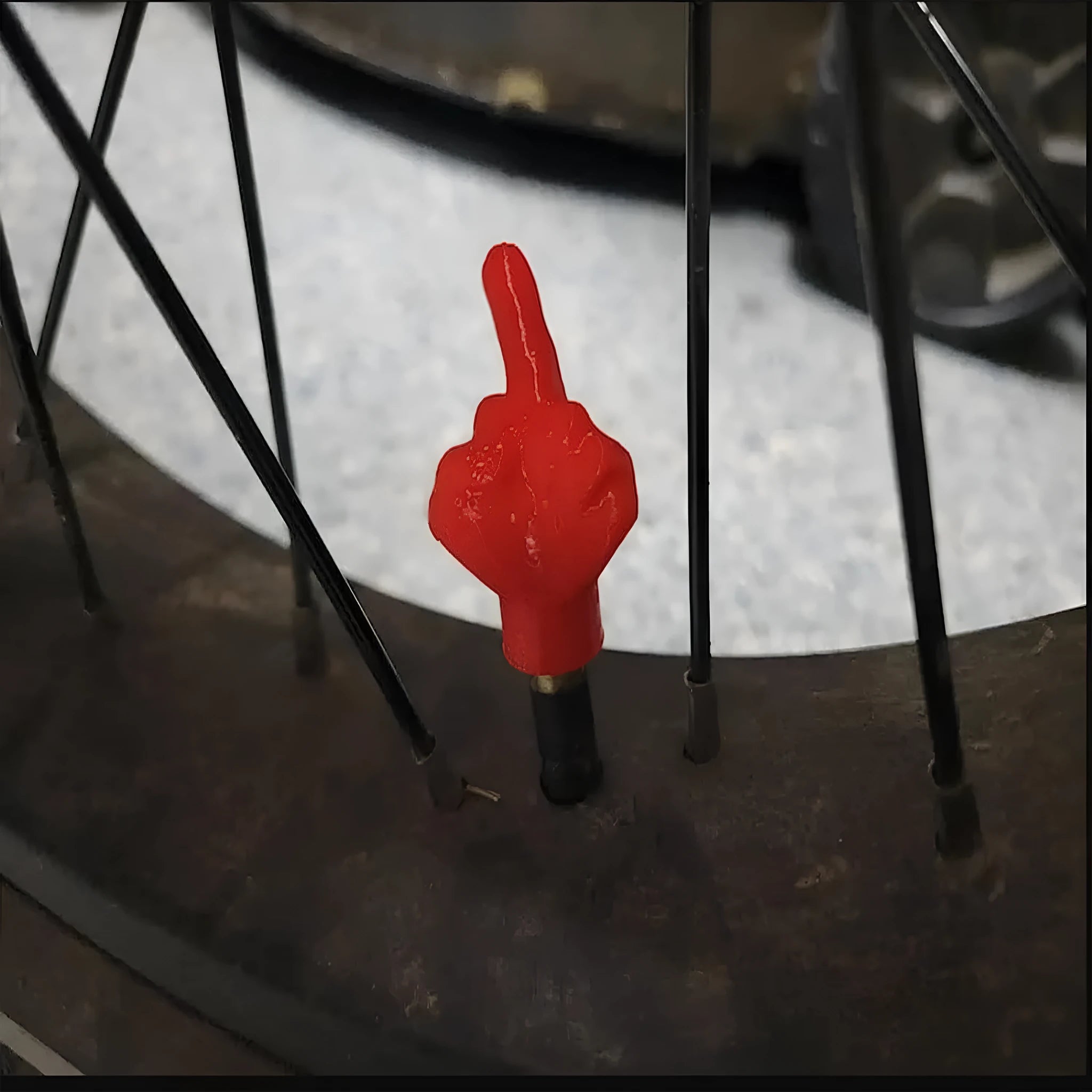 Eight car tyre valve caps, four black and four skin colour, made from latex.