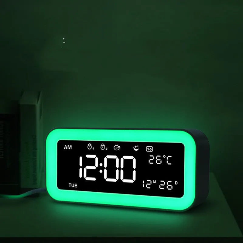 Blue rectangular LED atmosphere alarm clock with digital display on a desk.