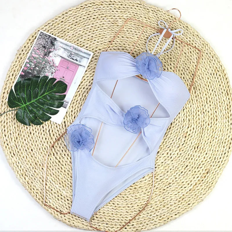 Women's black and blue stripe 3D floral print one-piece swimsuit on a hanger