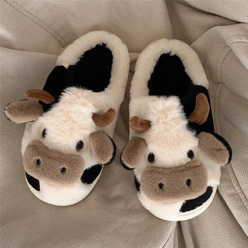 White cow-themed women's plush slippers with faux fur upper and textured non-slip sole