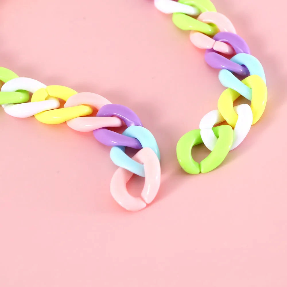 Adjustable plastic pet collar in macaron candy colours on a white background.