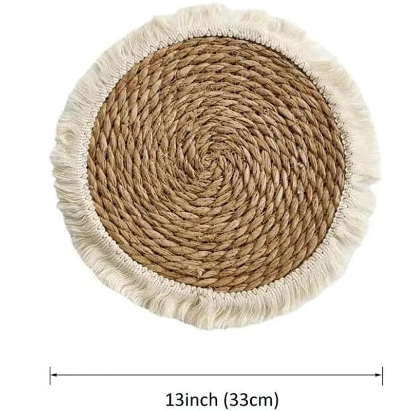 Round papyrus straw placemat with tassel edge in neutral colour on dining table