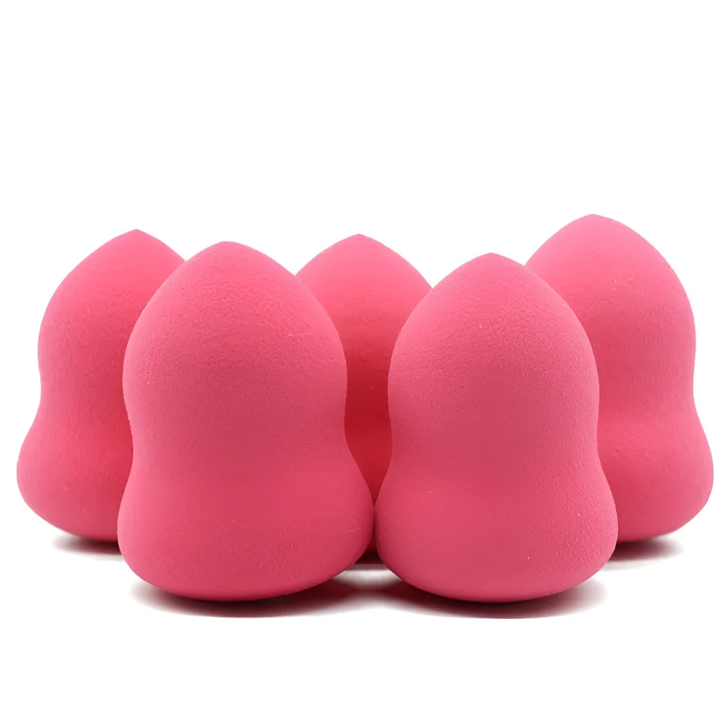 Pink cubic makeup foundation sponge puff on a clean surface.