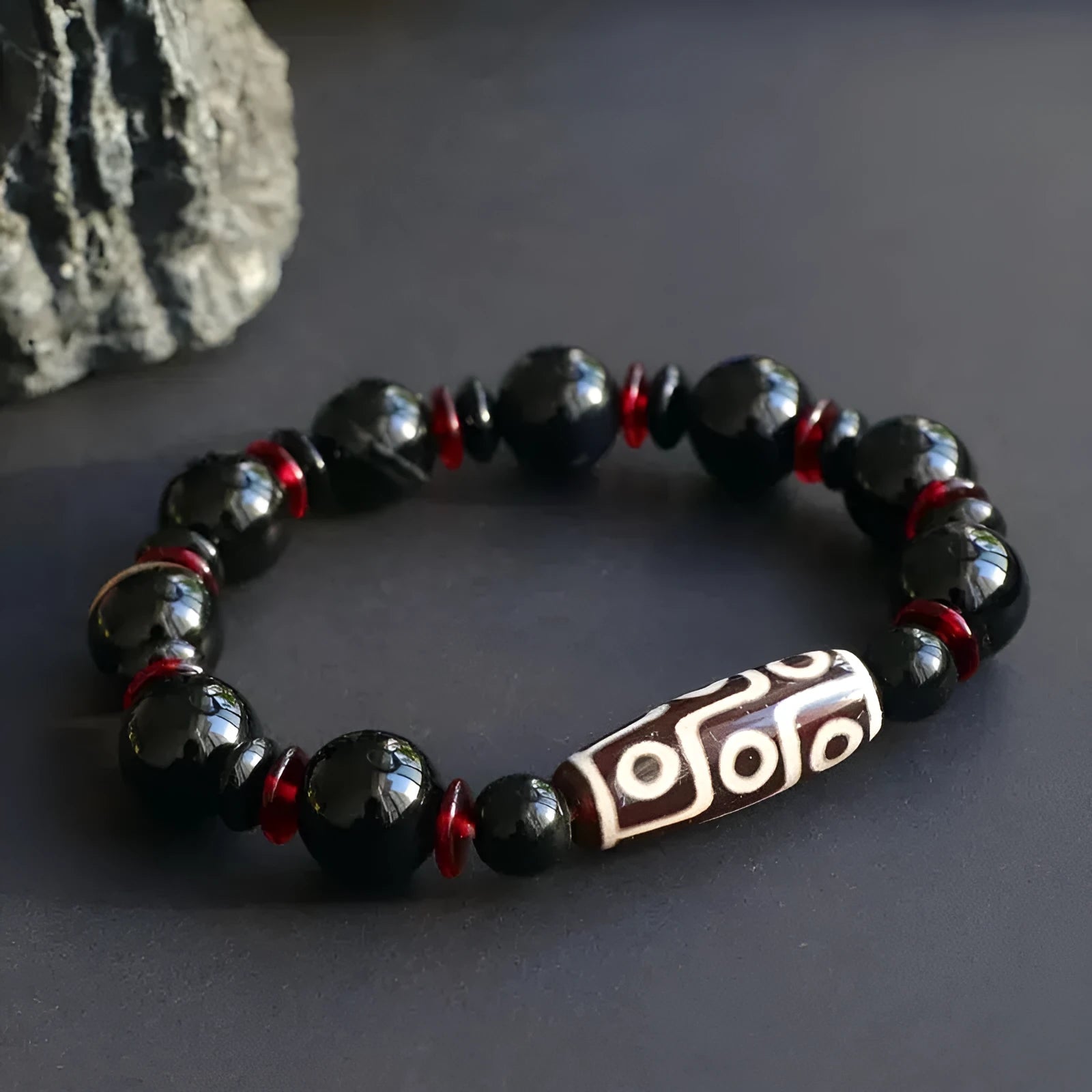 Black agate dzi bead bracelet with hand-woven construction and 11mm geometry beads