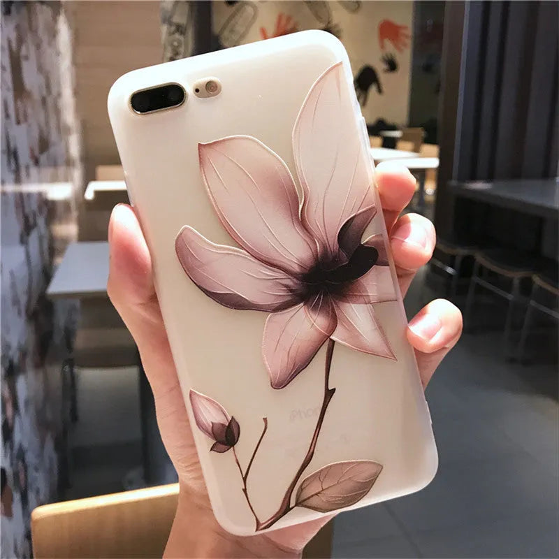 Black TPU iPhone case with a raised white embossed floral pattern on the back.