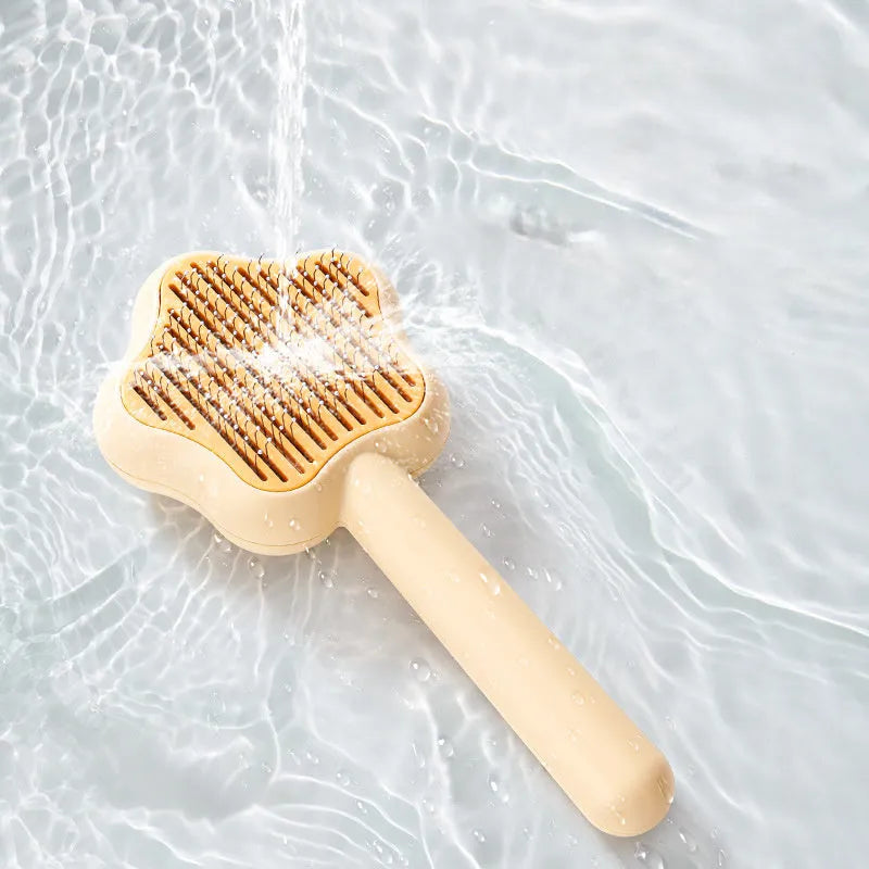Green pet grooming comb with stainless steel needles and self-cleaning mechanism