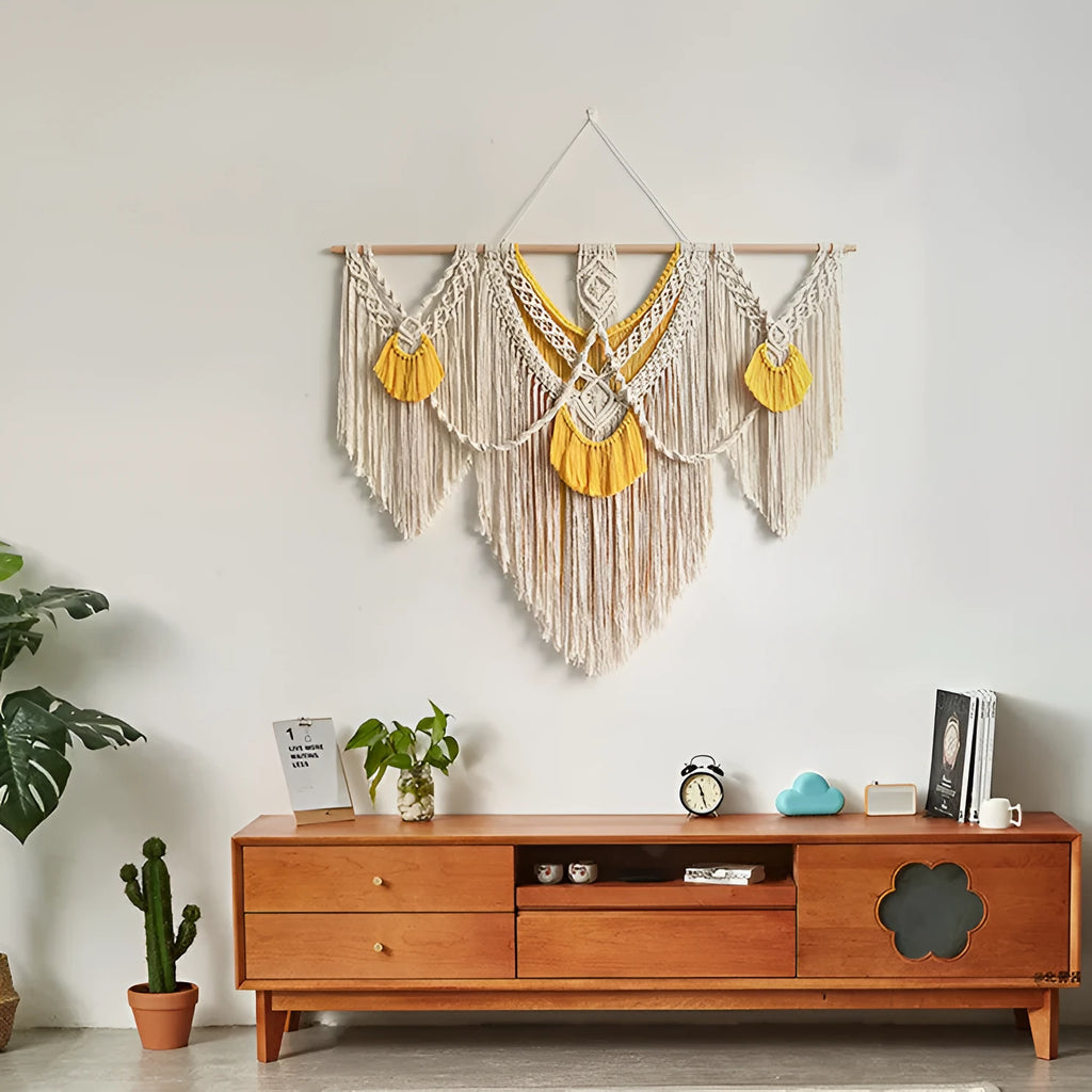 Hand-woven creamy white and yellow Nordic style cotton tapestry hanging on a wall
