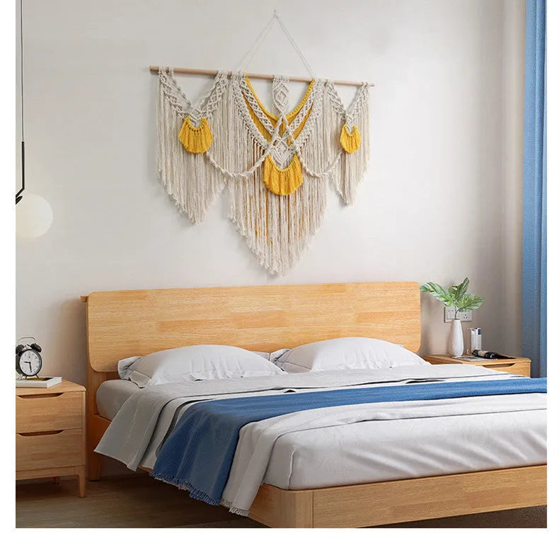 Hand-woven creamy white and yellow Nordic style cotton tapestry hanging on a wall
