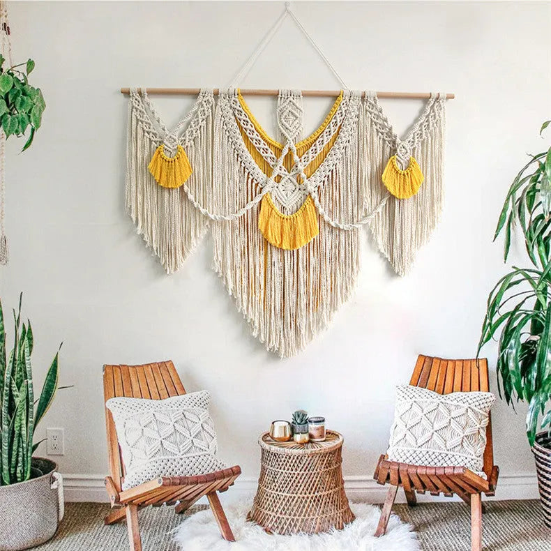 Hand-woven creamy white and yellow Nordic style cotton tapestry hanging on a wall