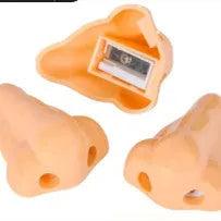 Flesh coloured plastic geometry design pencil sharpener with large casing, shown alongside a pencil.