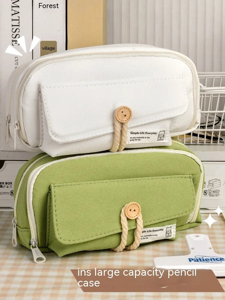 Large capacity Korean-style canvas pencil case for girls in green, holding multiple pens.