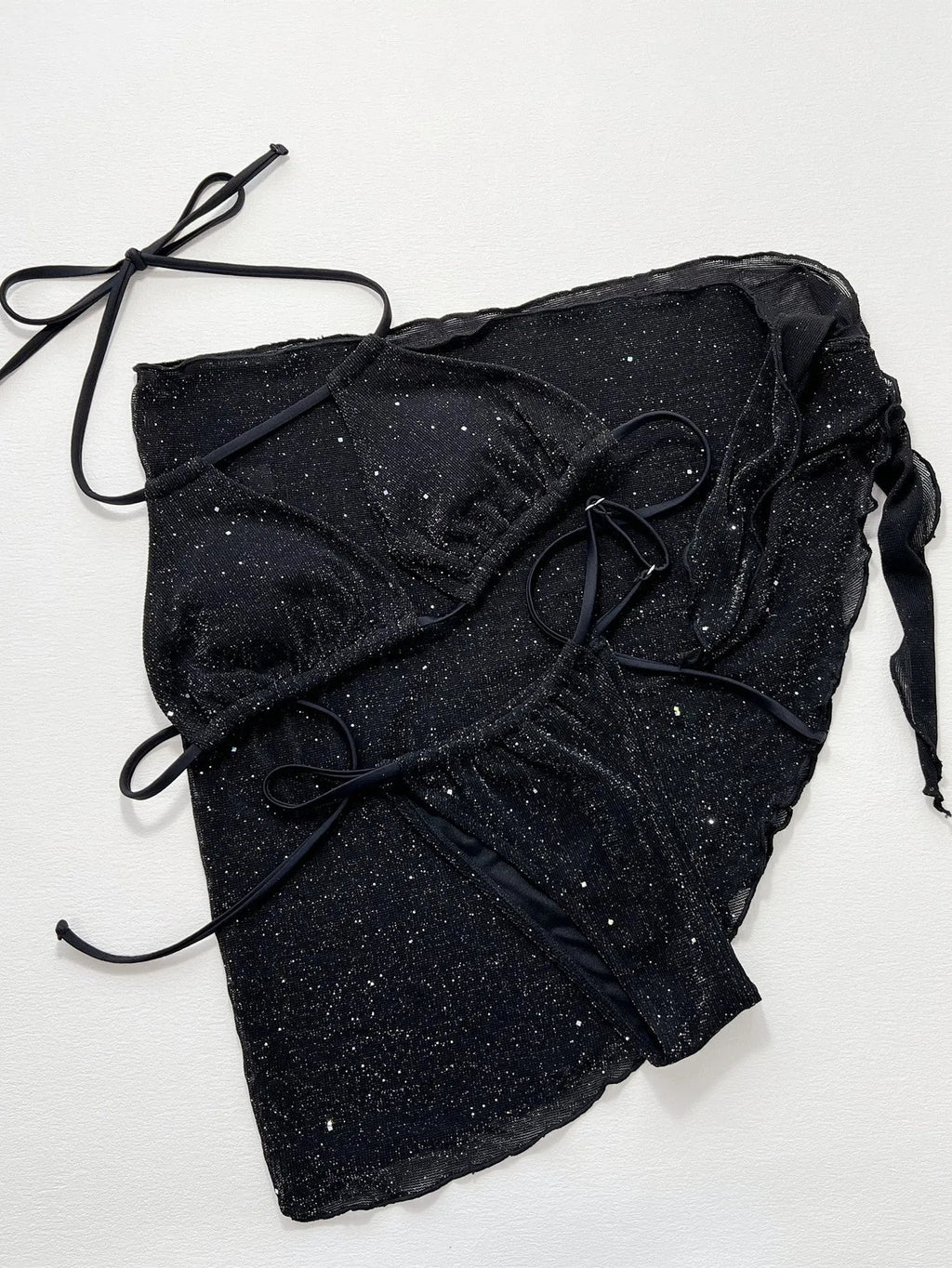 Black women's three-piece ruffled bikini set with matching shorts on a mannequin.