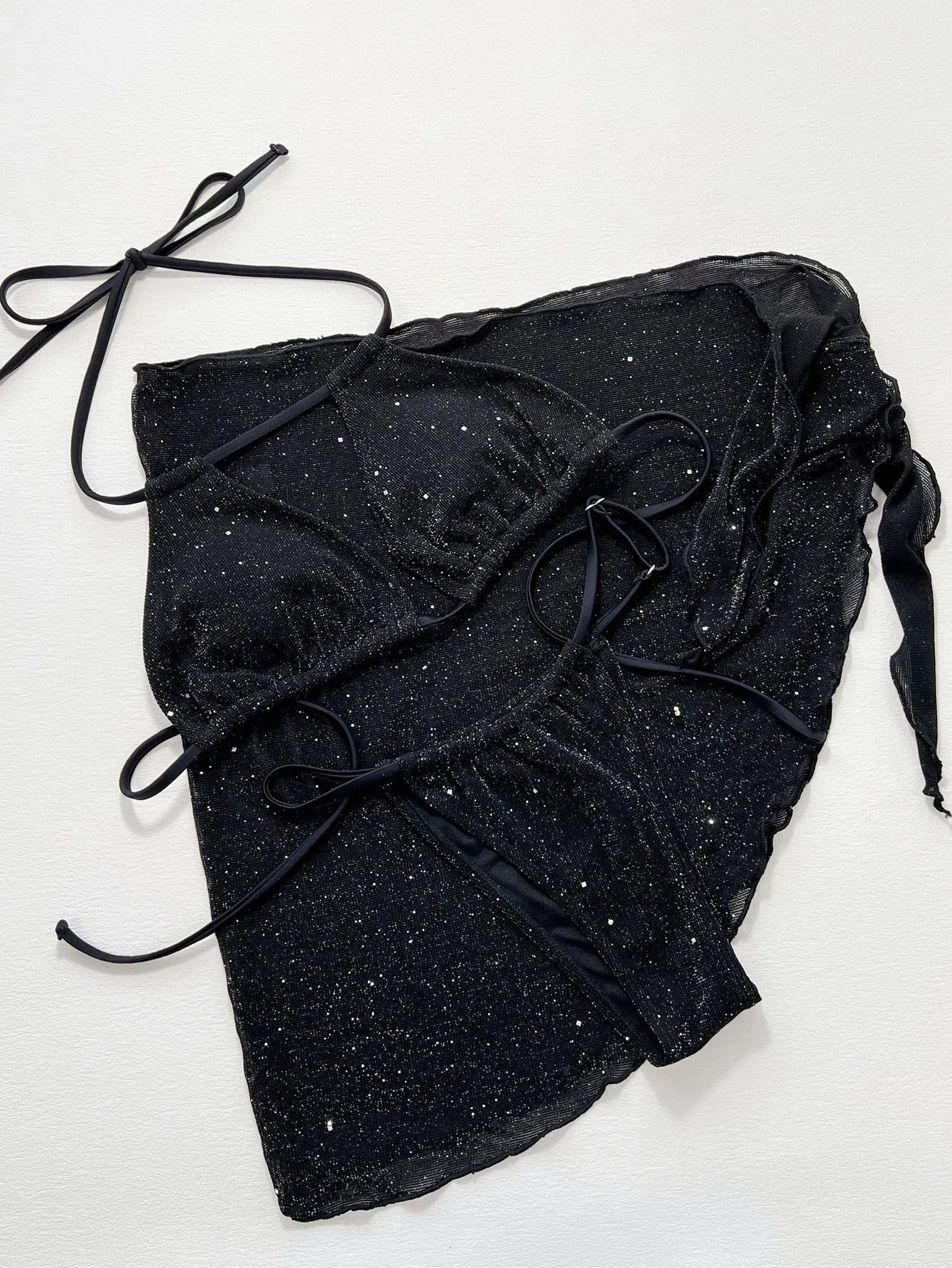 Black women's three-piece ruffled bikini set with matching shorts on a mannequin.