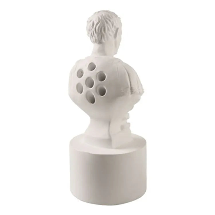 White synthetic resin American character pen holder on a desk.
